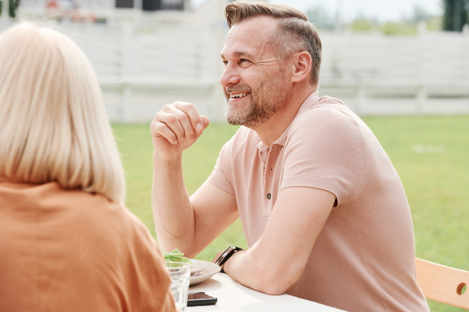 Couple relaxing at a table outdoors